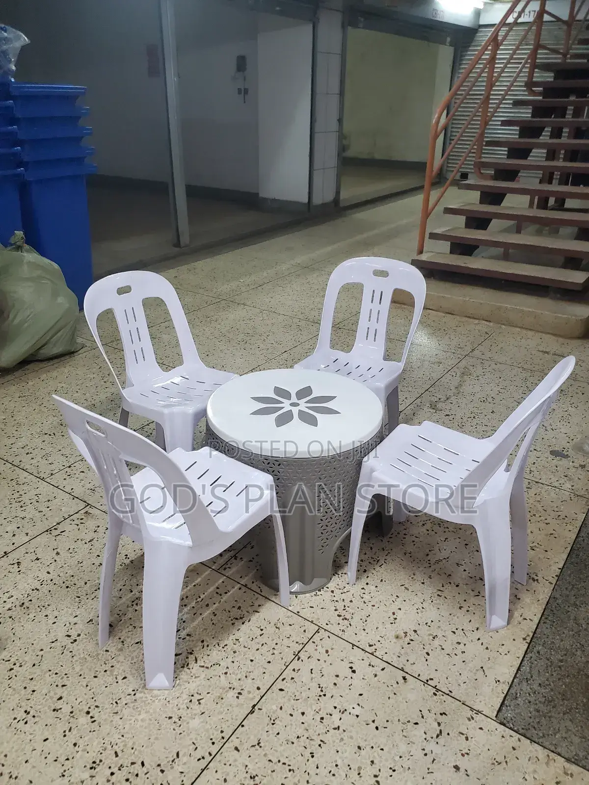 White Armless Plastic Chairs and Center Table