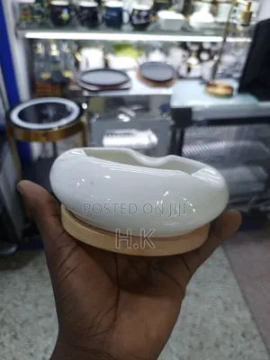 Ceramic Ashtray With a Wooden Base.