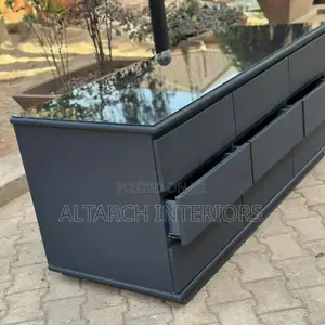 Chest of Drawers in Dark Grey and a Glass on Top