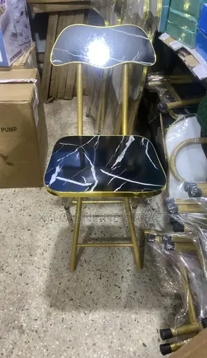Portable Foldable Chair With a Gold Color Metal