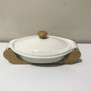 White Ceramic Casserole Dish With a Wooden Base