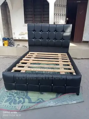 A Leather Bed With Sliver Shinny Buttons