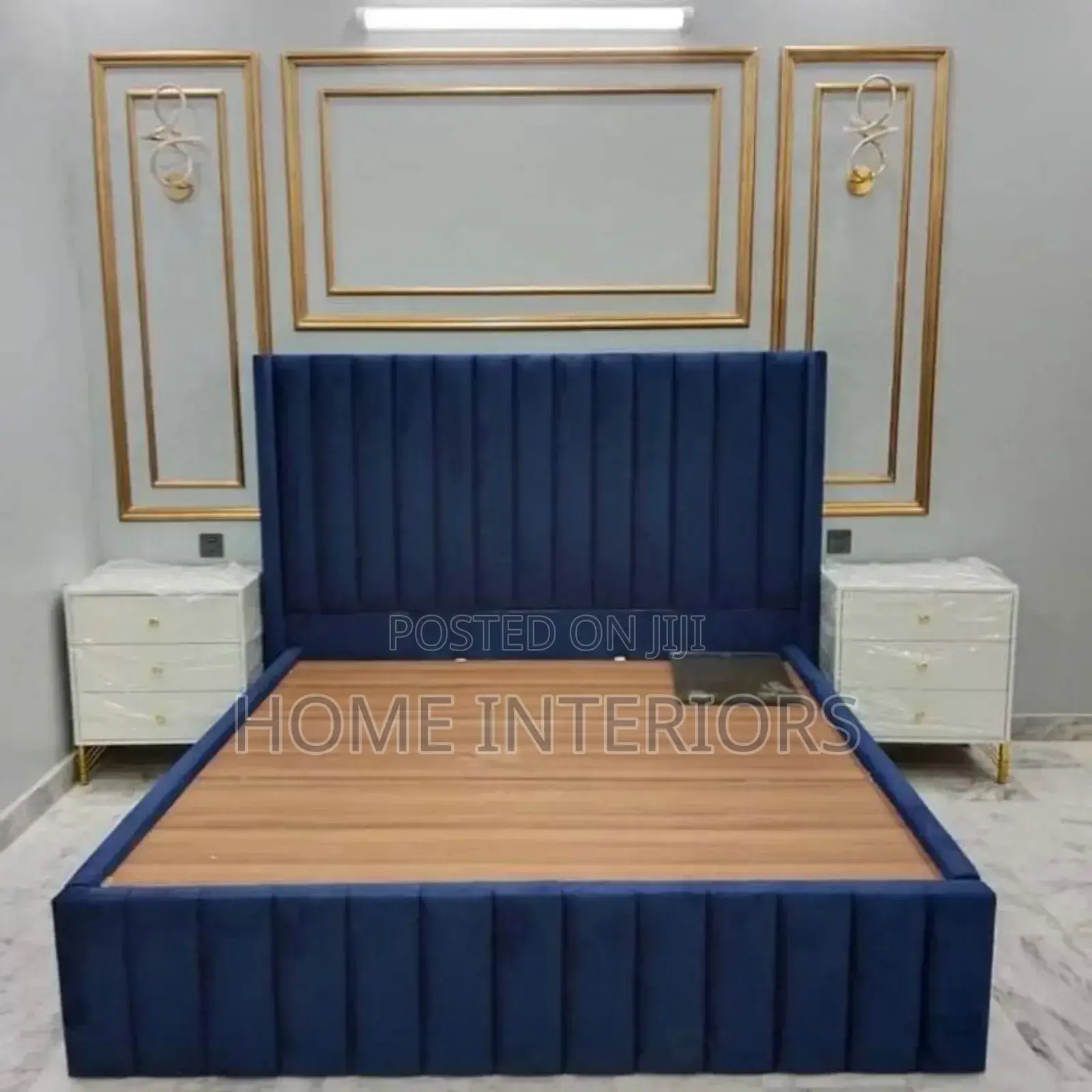A Navy Blue Bed With White Storage Drawers