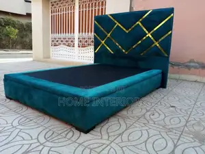A Light Green Color Bed With Golden Lines