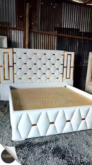 A White Leather Bed With Golden Lines