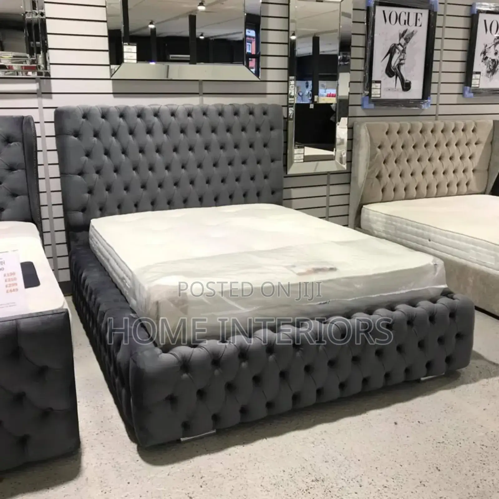 A Dark Gray Bed With a Mattress