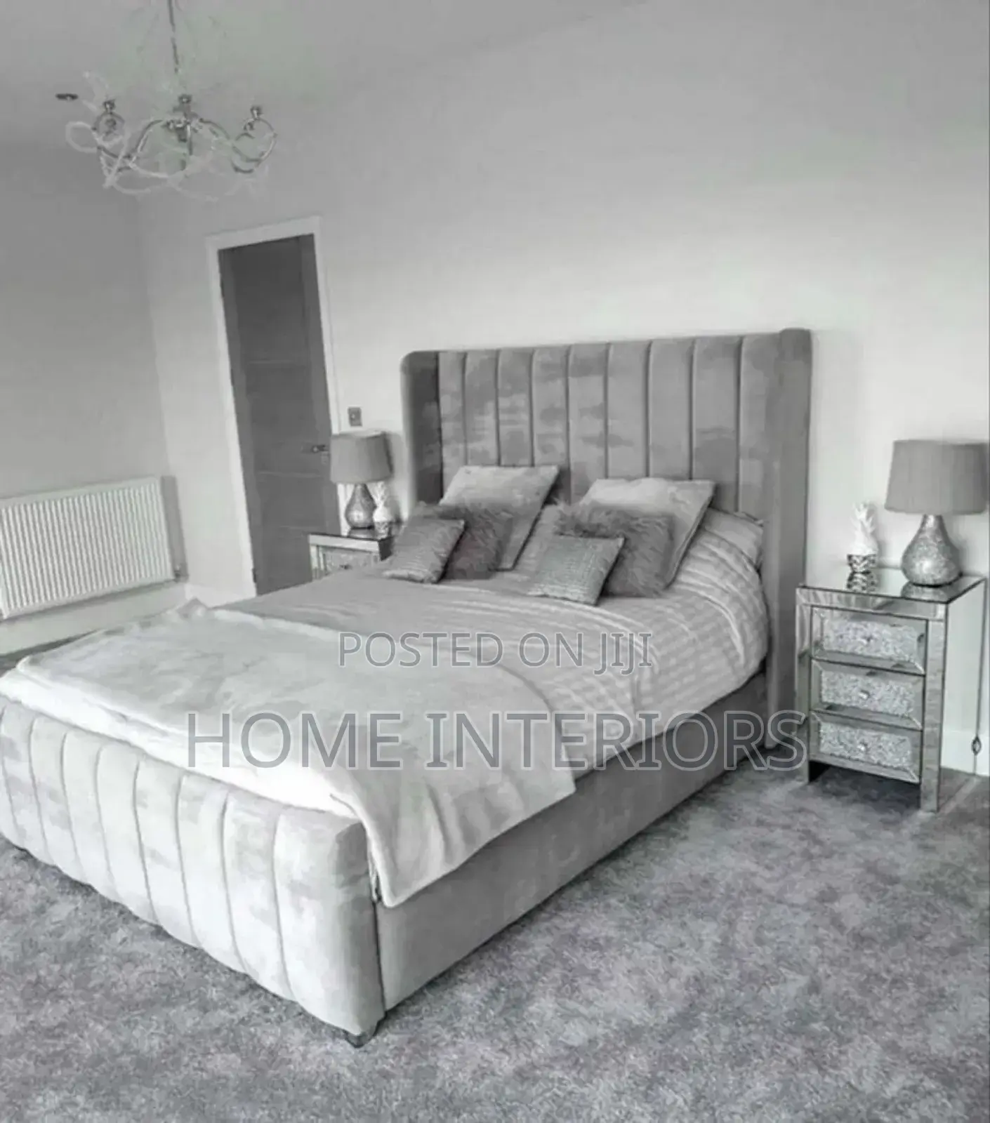 A Light Gray Colored Bed With a Mattress