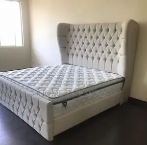 Light Gray Colored Bed With a Mattress