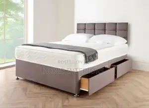 A Gray Colored Bed With Two Storage Drawers