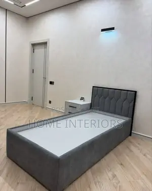 A Bed in Gray Colored With One Drawer