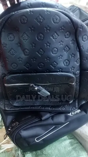 A Black Faux Leather Backpack With a Monogram Pattern