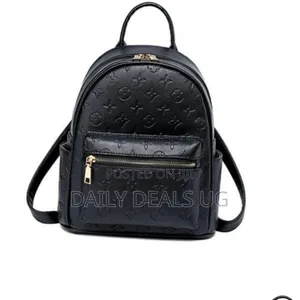 A Black Faux Leather Backpack With a Monogram Pattern