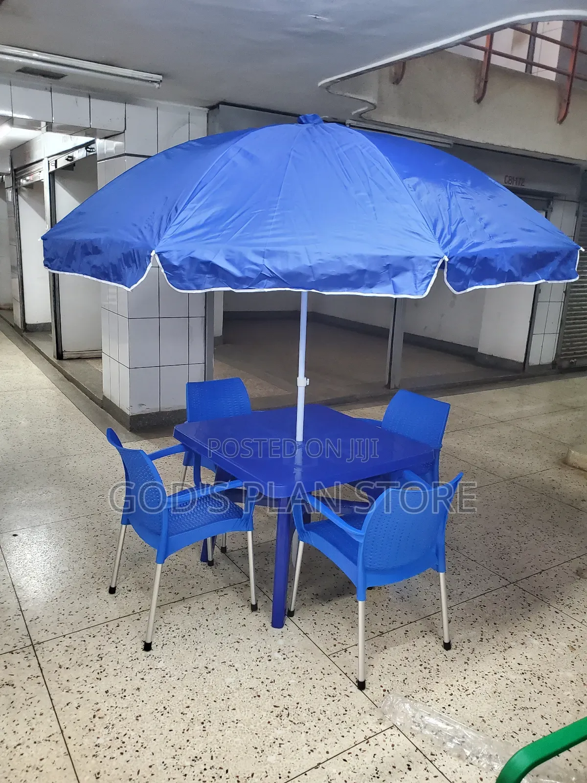 Blue Umbrella and Plastic Chairs and Blue Plastic Table