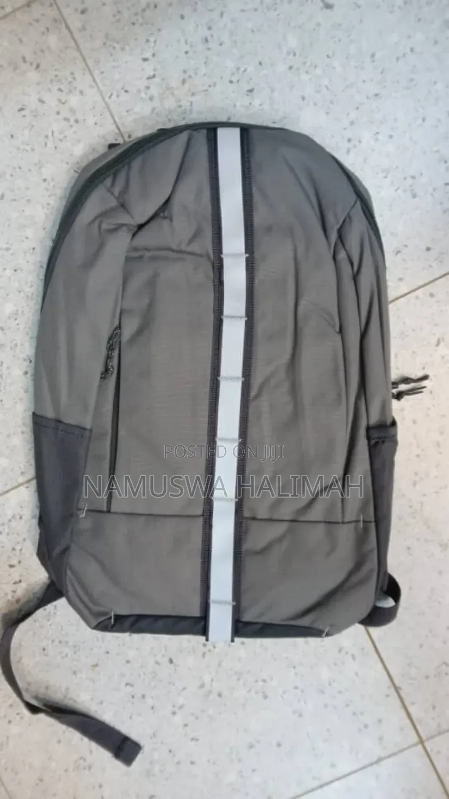 Gray Laptop Backpack With a Reflective Stripe.