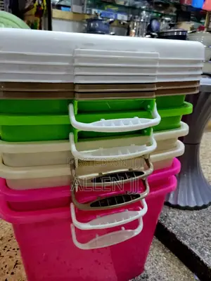 Several Stackable Plastic Storage Containers With Lids and Handles.
