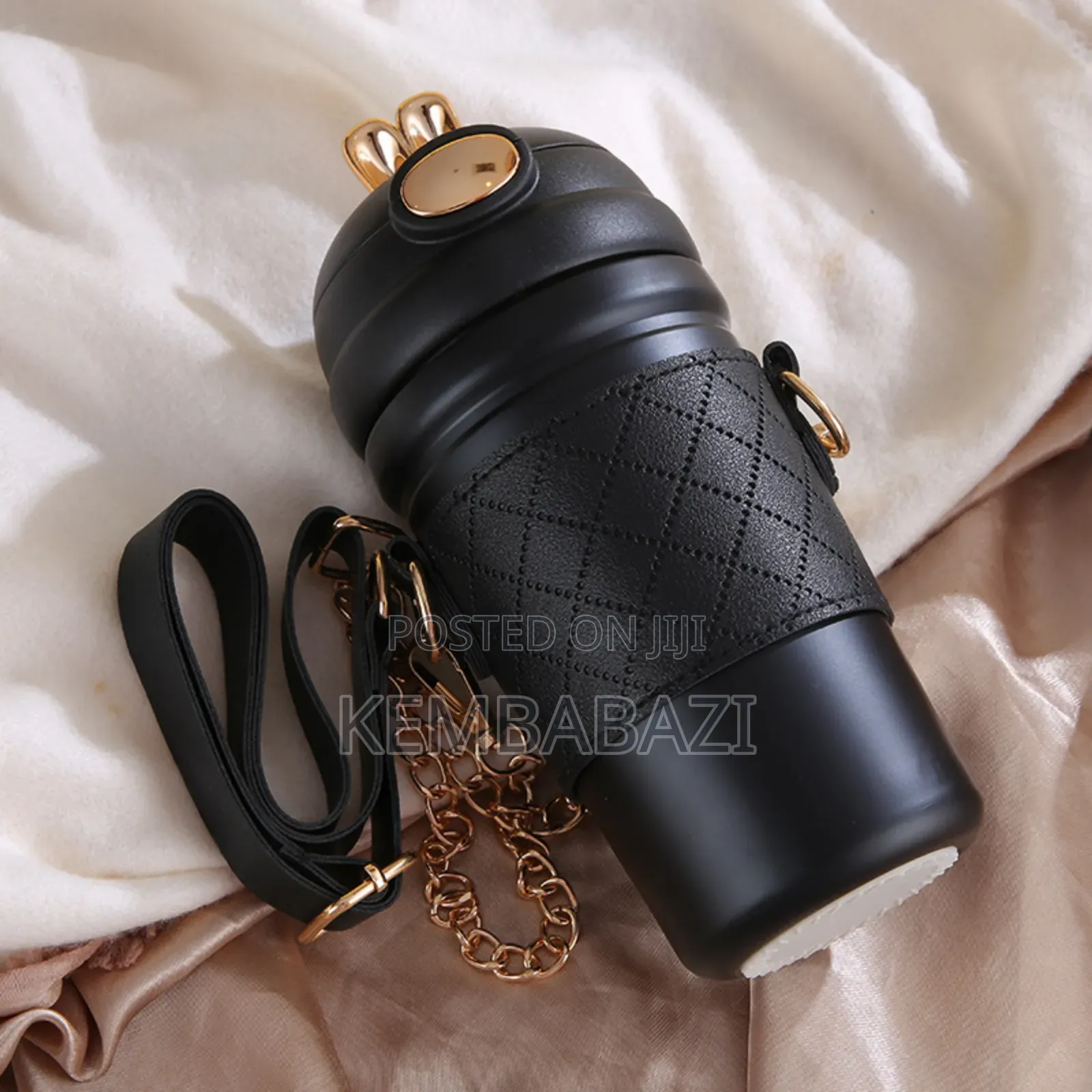 Stainless Steel Thermos Bottle With a Leather Sleeve.