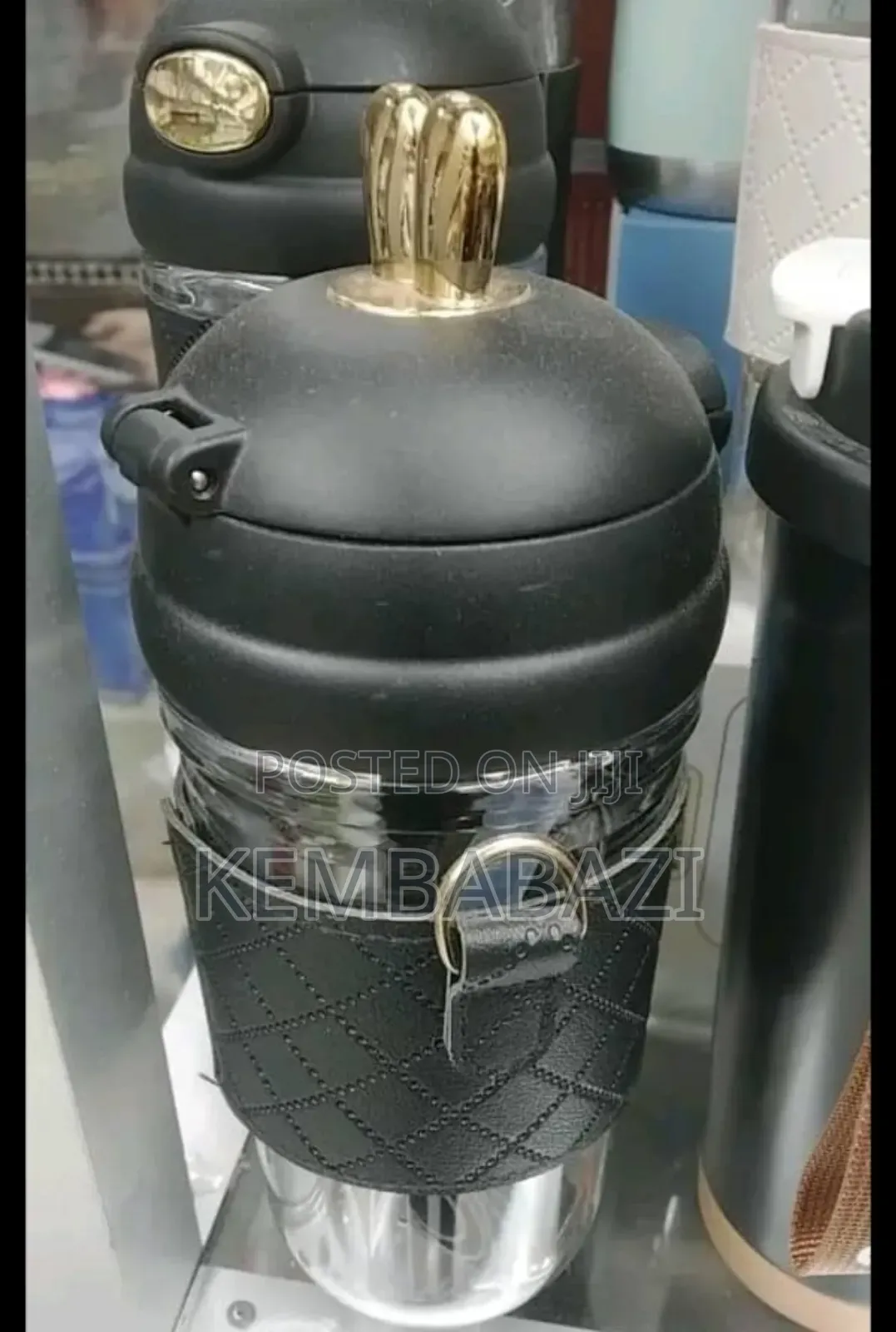Stainless Steel Thermos Bottle With a Leather Sleeve.