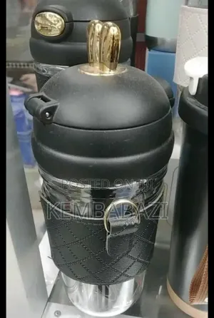 Stainless Steel Thermos Bottle With a Leather Sleeve.