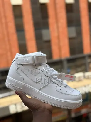 White Nike Air Force 1 Mid Sneakers.