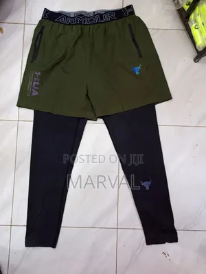A Pair of Black and Olive Green Under Armour Athletic Pants.