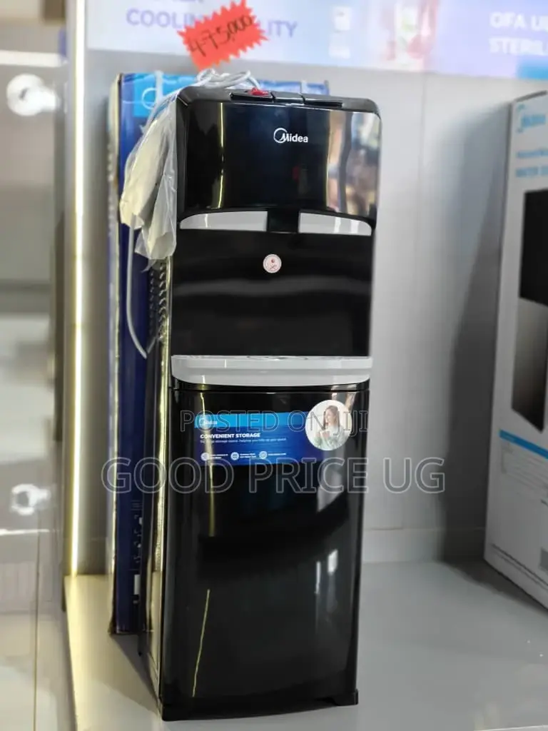 A Black Midea Yl1632s Top Loading Water Dispenser With Bottom Cabinet