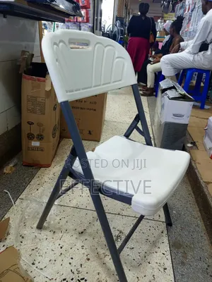 Plastic Folding Chair With a Grey Metal Frame.