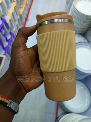 Insulated Travel Coffee Mug With a Lid and a Silicone Grip Sleeve.