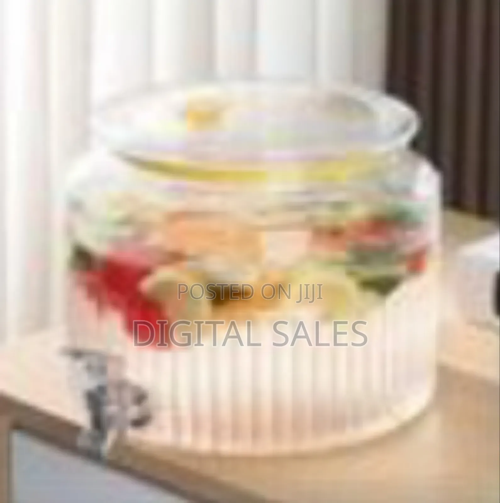Ribbed Glass Beverage Dispenser With a Spigot.