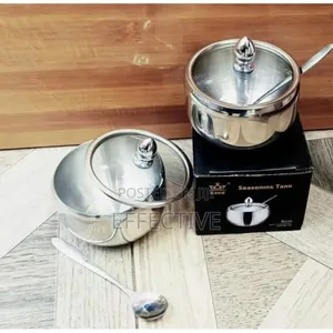 Stainless Steel Sugar Bowl With a Glass Lid and Spoon.