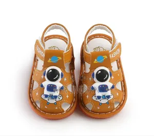 Babypro Brown Infant Squeaky Sandals With an Astronaut Design.