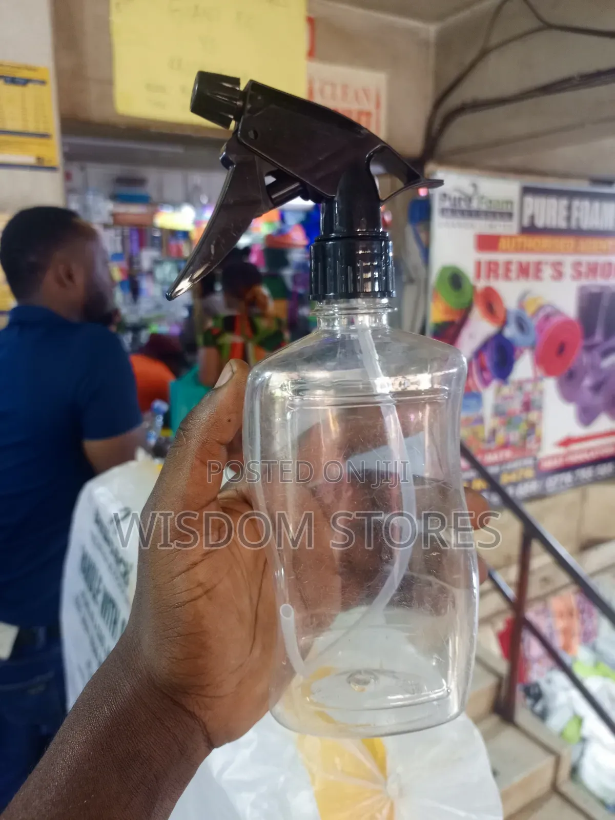 Clear Plastic Spray Bottle With A Black Trigger Sprayer.