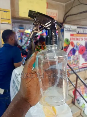 Clear Plastic Spray Bottle With A Black Trigger Sprayer.