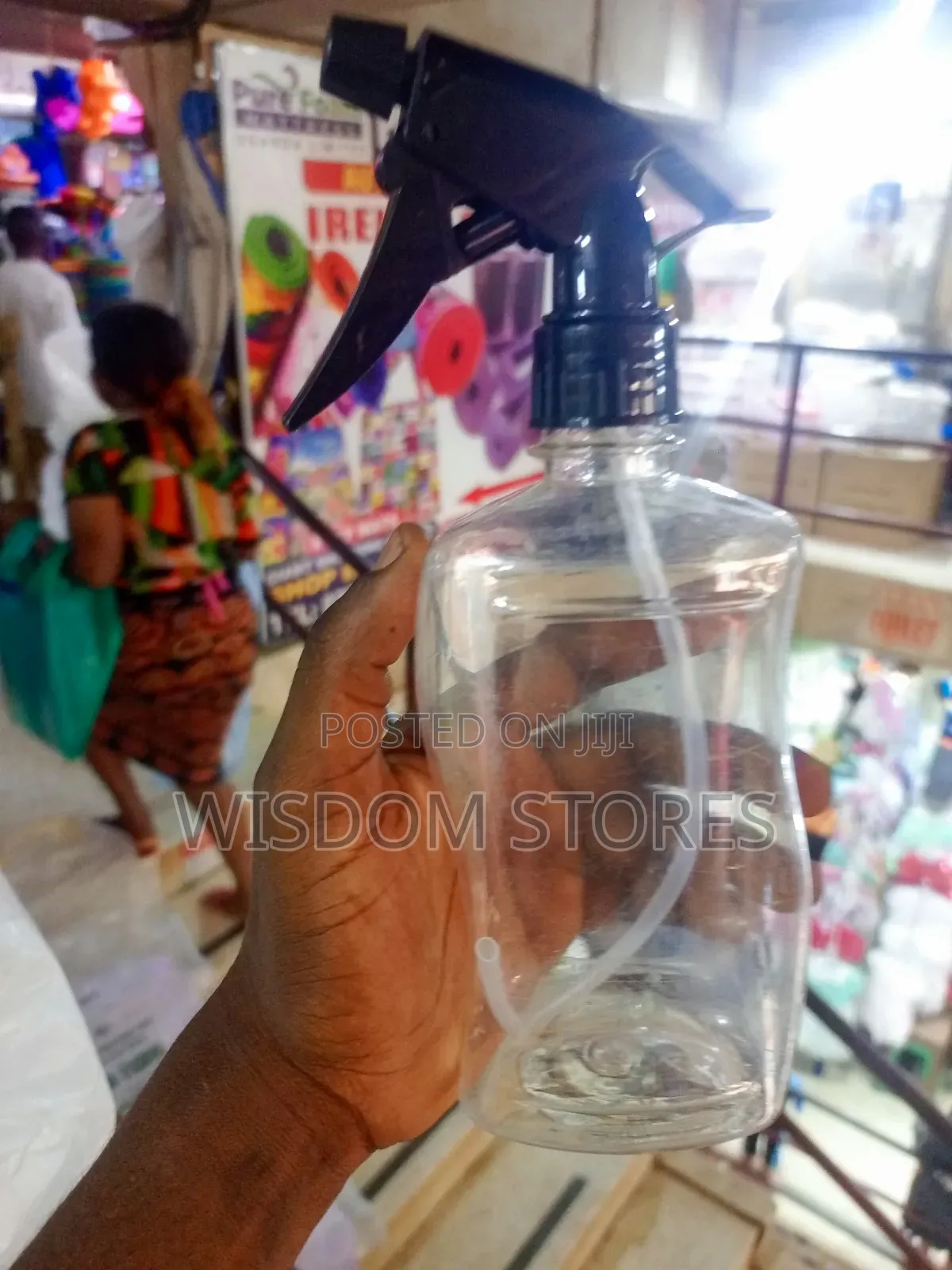 Clear Plastic Spray Bottle With A Black Trigger Sprayer.