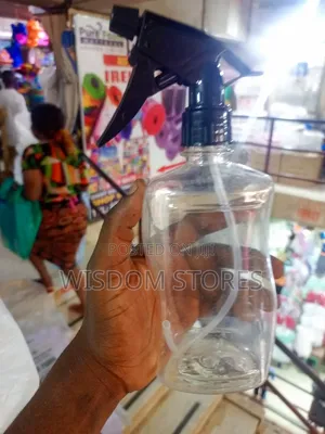 Clear Plastic Spray Bottle With A Black Trigger Sprayer.