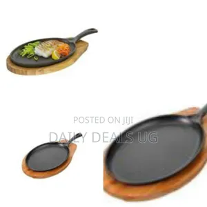 Oval Cast Iron Serving Pan With a Wooden Board