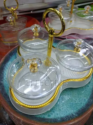 Serving Tray With a Gold Metal Stand and Lid.