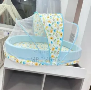 Portable Baby Travel Bed With An Integrated Mosquito Net