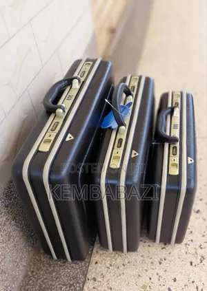 A Set of Three Black Hard-Shell Briefcases