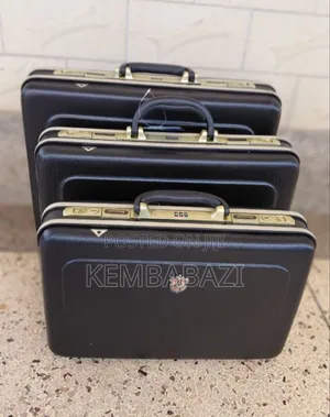 A Set of Three Black Hard-Shell Briefcases