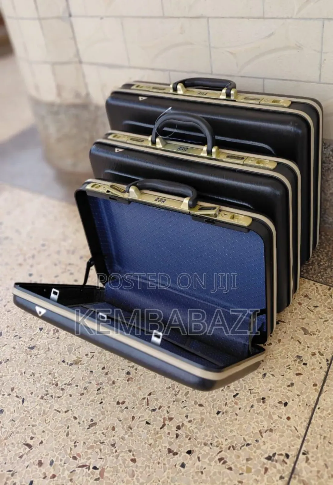 A Set of Three Black Hard-Shell Briefcases