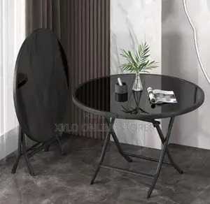 A Modern Folding Round Table With a Black Tempered Glass Table Top