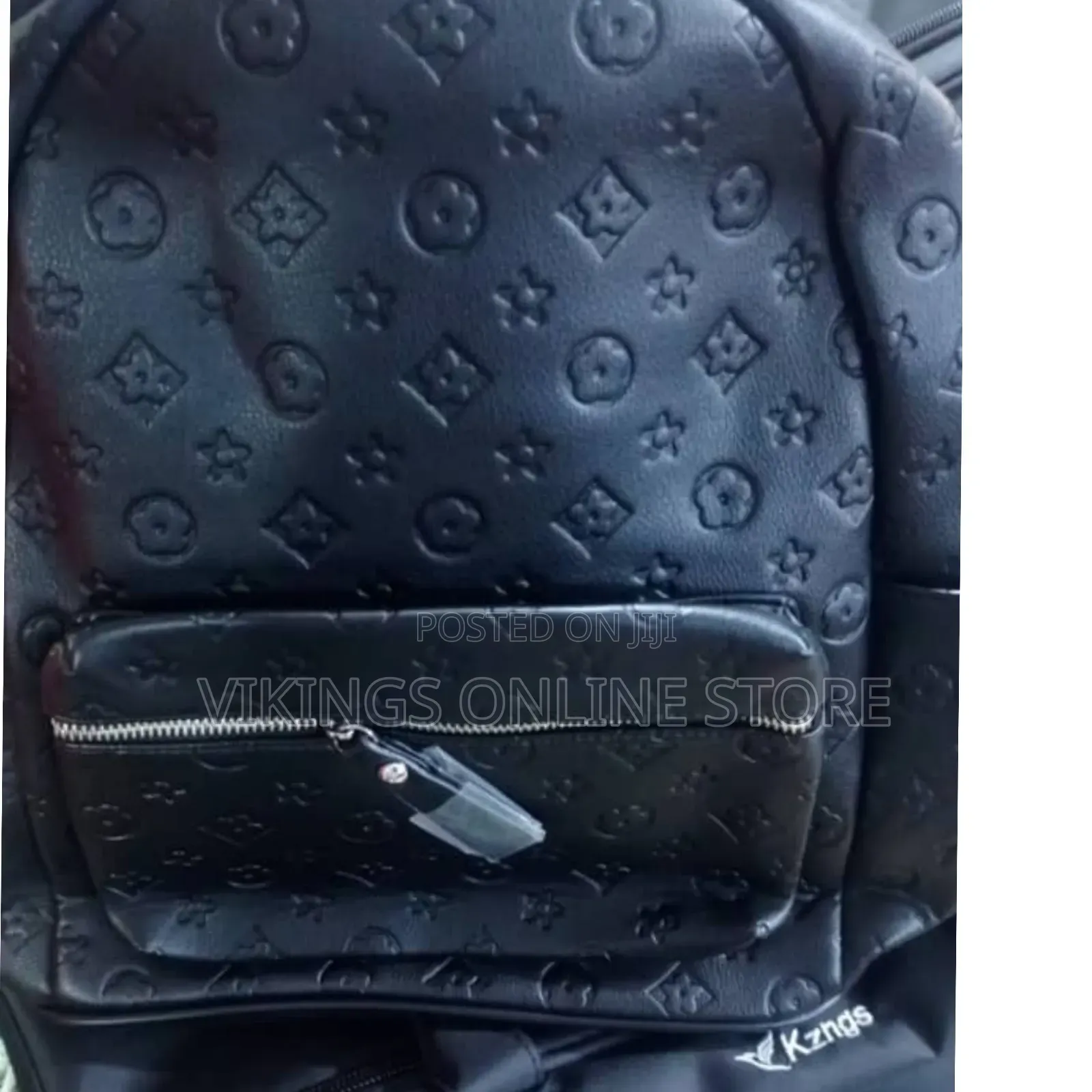 An Embossed Monogram Mini Backpack Bag