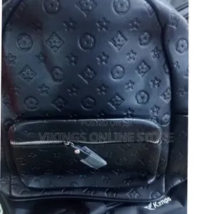 An Embossed Monogram Mini Backpack Bag