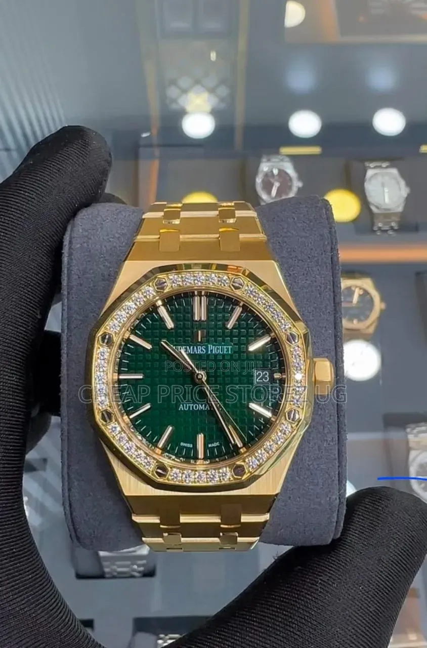 This Is a Audemars Piguet Royal Oak in Yellow Gold With a Green Dial.