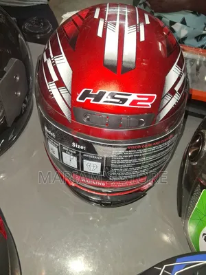 Red and White Ls2 Full-Face Motorcycle Helmet With Graphic Details.