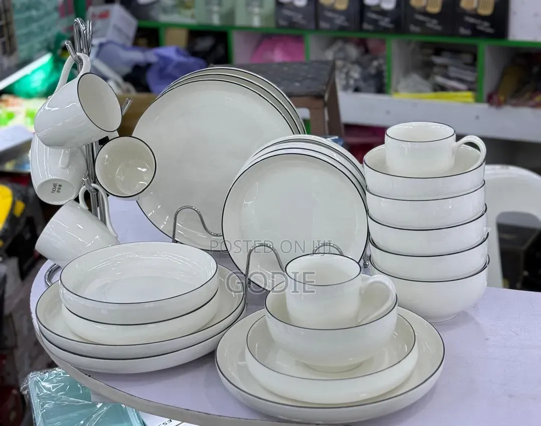 24 Pc Dinnerware Set With a Modern White Design With a Sleek Black Rim