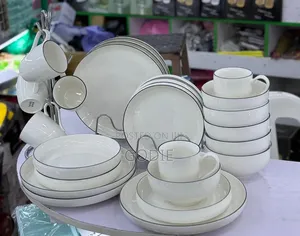 24 Pc Dinnerware Set With a Modern White Design With a Sleek Black Rim
