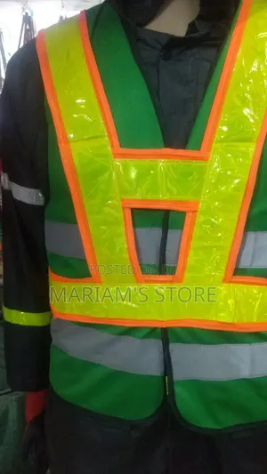 Green Safety Vests Featuring Fluorescent Orange Trim .