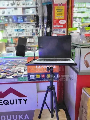 Laptop Stand With an Attached Phone Holder Mounted on a Tripod