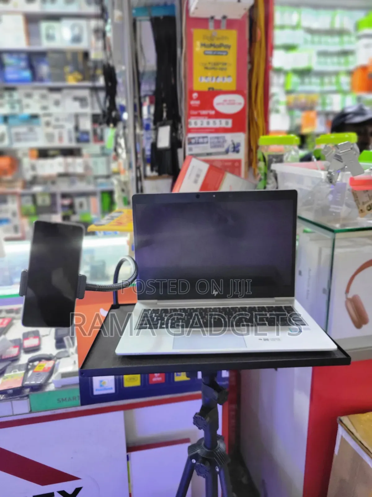 Laptop Stand With an Attached Phone Holder Mounted on a Tripod